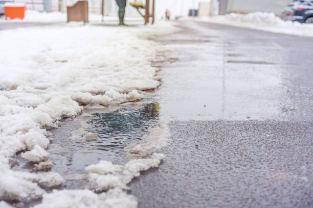 istock water flows on sidewalk in city street 1195385780