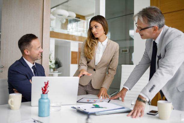 istock Senior manager and his staff analyzing the business charts 1195387178