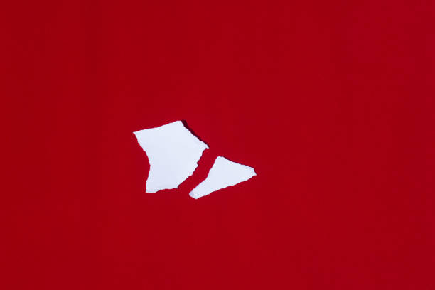 istock White paper broken into pieces on a red background 1195387991