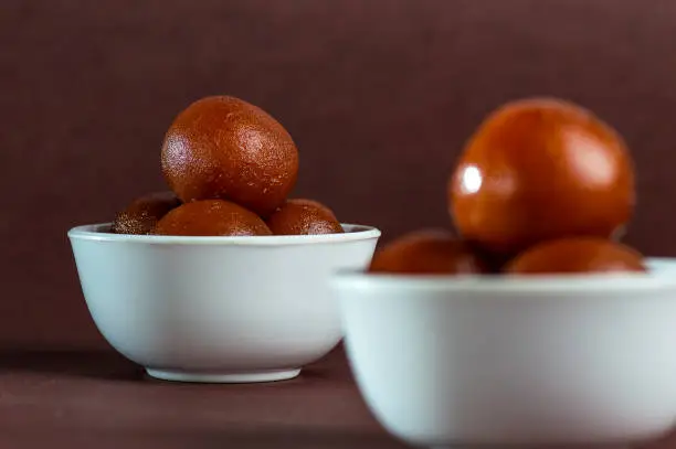 Photo of Gulab Jamun, Indian Dessert or Sweet Dish in bowl with spoon