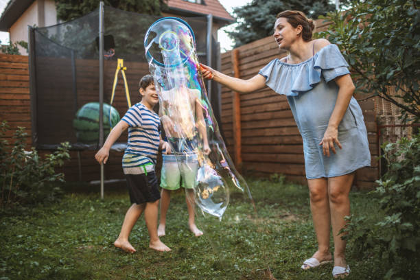 istock Mother playing with her sons with soap bubbles 1195391851