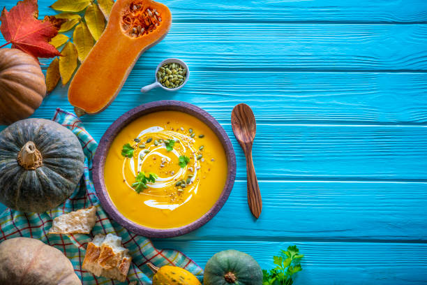 istock Autumn pumpkin soup and ingredients on turquoise 1195392628