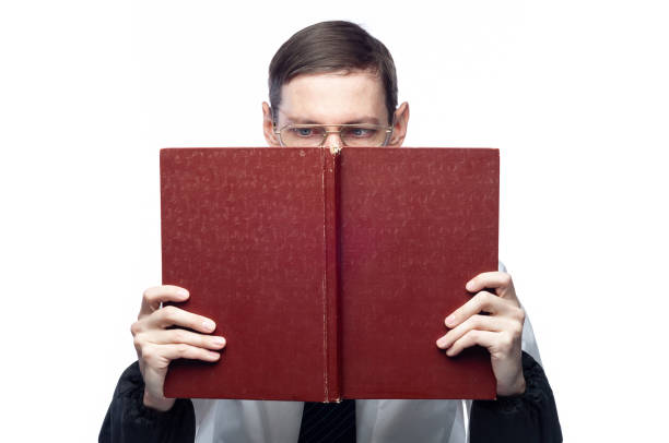 istock The man's face is covered by a large red notebook, on an isolated background 1195392783