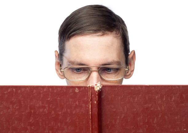 istock The man's face is covered by a large red notebook, on an isolated background 1195392785