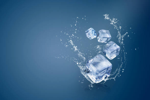 istock Water splashing on Ice cubes isolated over a blue background and copy space 1195392898