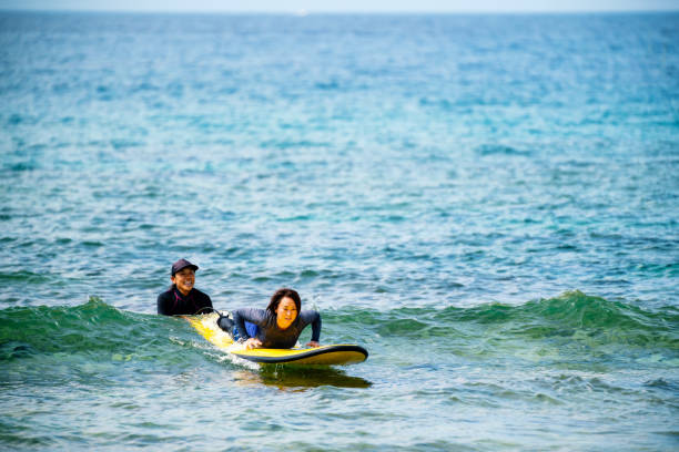 istock Mature women taking a surfing lesson 1195393514