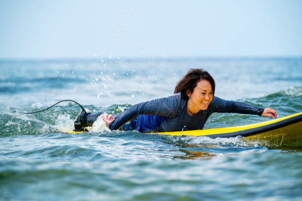 istock Mature women learning to surf 1195393521