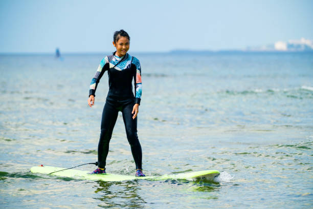 istock Twelve year old girl surfing 1195393580