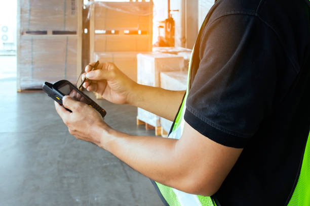 istock Worker hand holding barcode scanner his inspecting order delivering shipment goods. 1195393599