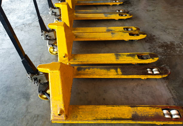 istock Yellow hand pallet truck equipment unloading in warehouse 1195393603