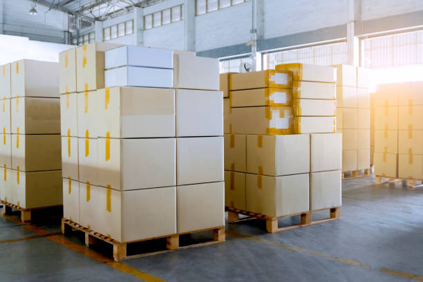 istock Stack package boxes on wooden pallets in interior of warehouse 1195393633