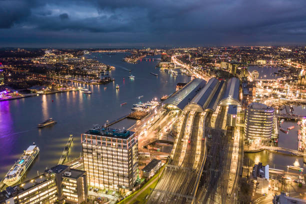 istock Amsterdam Centraal Train Station at Night Aerial View 1195394119
