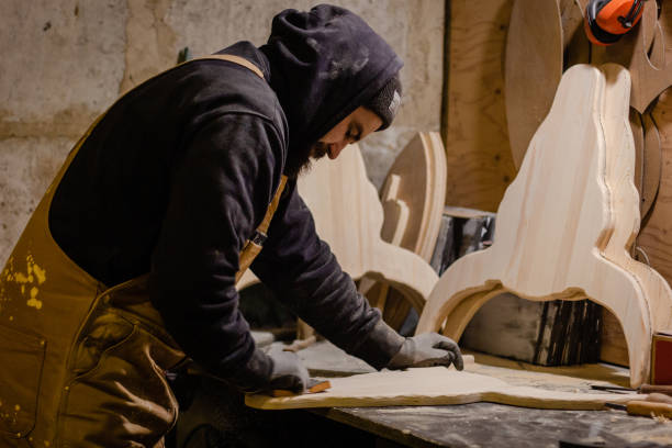 istock Carpenter polishing wood in workshop 1195395006