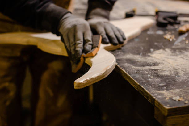 istock Carpenter polishing wood in workshop 1195395007