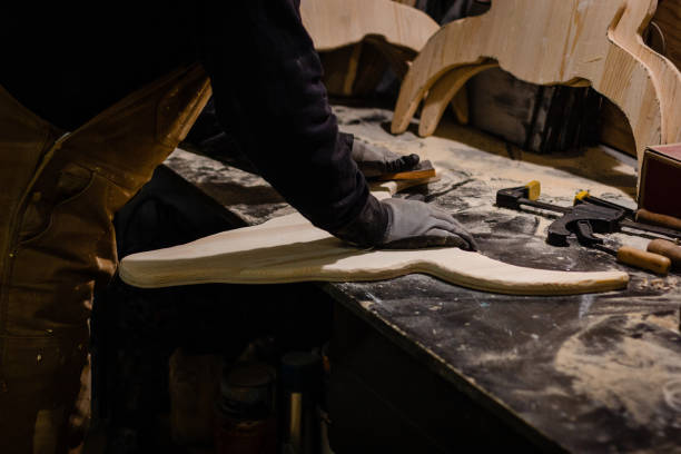 istock Carpenter polishing wood in workshop 1195395010