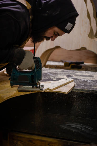 istock Carpenter working with an electric jigsaw 1195395019