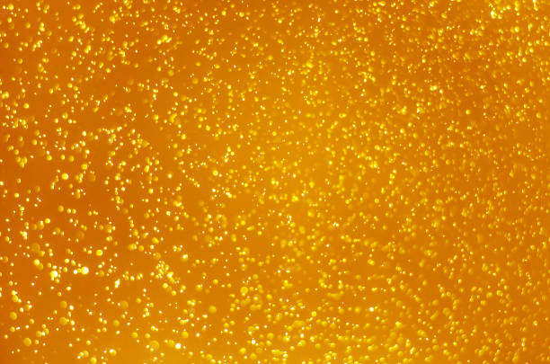 istock abstract yellow bokeh glitter sparkle background. 1195398195