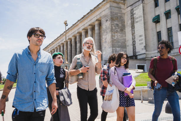 istock Professor guuding students on a tour around campus 1195399267