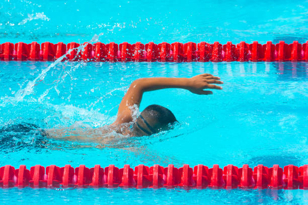 istock ASIAN BOY  SPRINTS FREESTYLE SWIMMING 1195400638