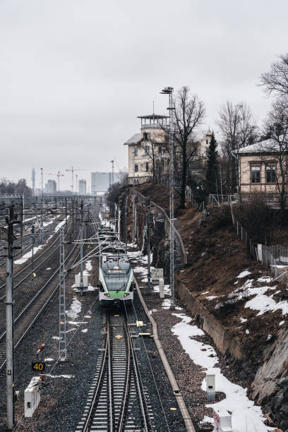 istock Train moving on the rails towards Helsinki on a misty spring day with some snow left 1195406377