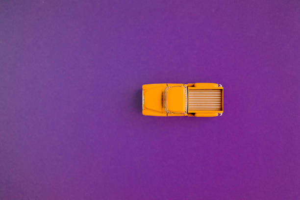 istock Yellow Retro car pickup on a blue-purple background. Top view with copy space. Flat lay 1195406537