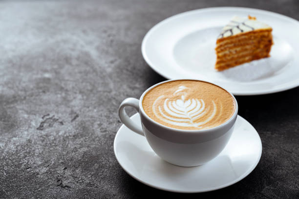 istock cup of coffee and cake on black stone background 1195406677