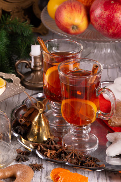 istock Two glasses with mulled wine on a tray with christmas accessories 1195407442