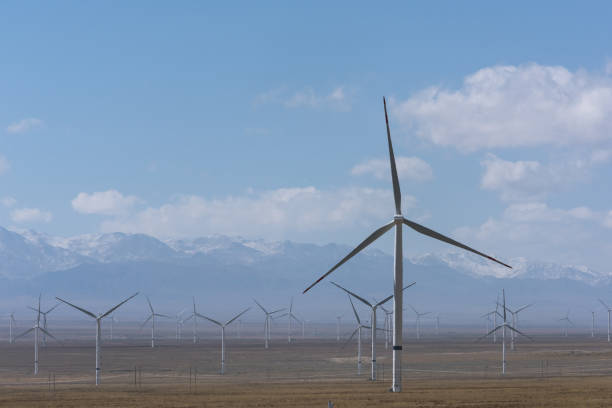 istock wind power plant on dry grassland 1195407462