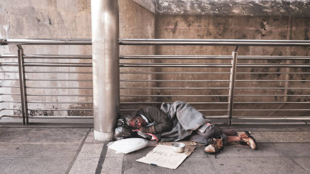 istock Homeless man sleeping on outdoor floor. 1195407716
