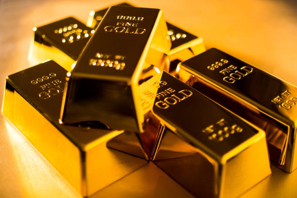 istock Shiny fine gold bullions on a gold background. 1195409299