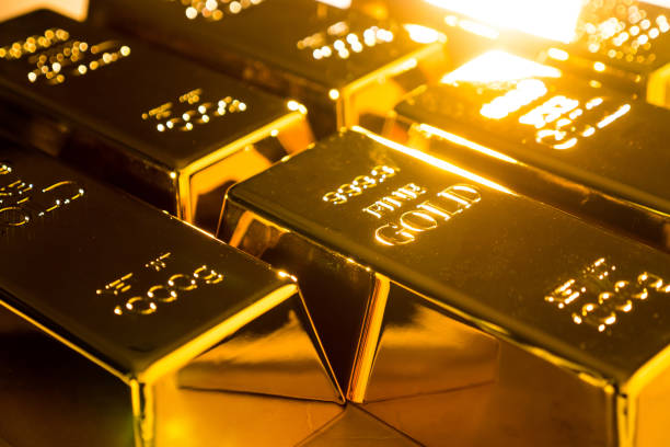 istock Shiny fine gold bullions on a gold background. 1195409338