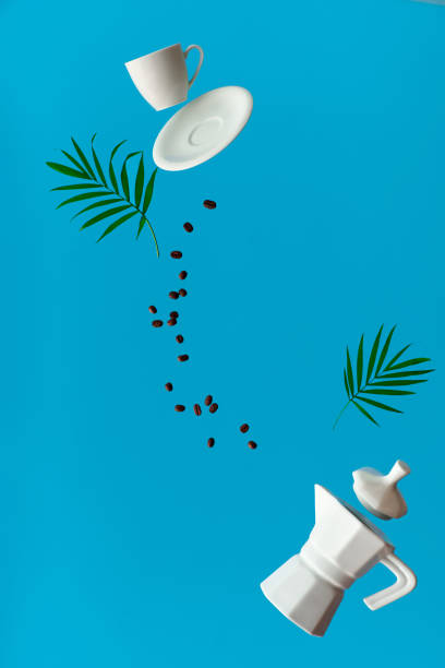 Trendy levitation. Flying line of coffee beans between ceramic coffee maker and espresso cup with saucer. Blue mint background with palm leaves.