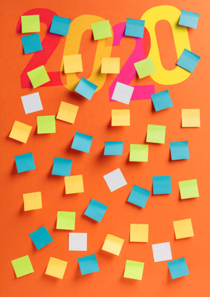 istock Reminder concept for 2020. Empty colorful stickers on a orange background. 1195410587