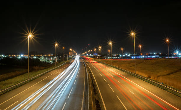istock Car light trails on highway A12 in The Netherlands at night. 1195410701