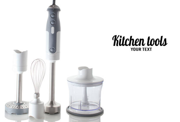 istock Kitchen tools.Electric hand mixer. Set of nozzles and  containers for blender. Isolated objects on a reflective surface. Copy space 1195411408