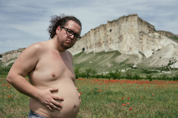 istock Funny fat man with a big belly. 1195412343