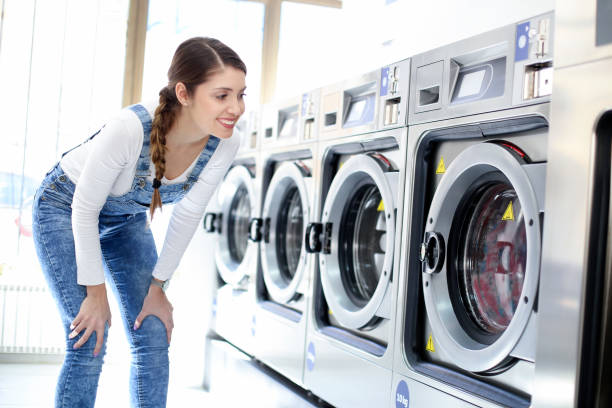 istock Young woman at a laundromat 1195412685