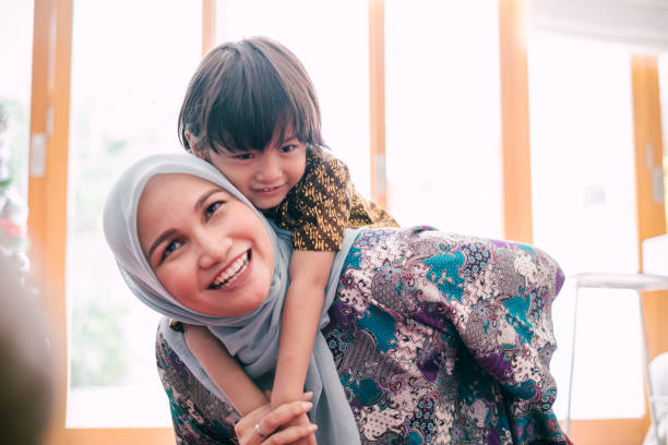 istock Beautiful Mother Piggyback Her Son 1195413538