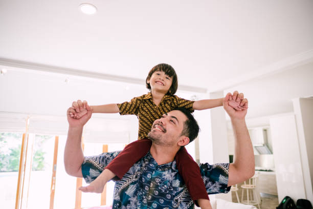 istock Young Asian Father Piggyback His Son 1195413610