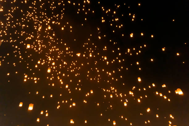 istock Thai people release sky floating lanterns or lamp to worship Buddha's relics at night. Traditional festival in Chiang mai, Thailand. Loy krathong and Yi Peng Lanna ceremony. Celebration background. 1195413773