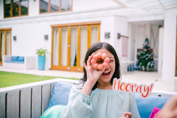 Teenage Girl Looking Through Donut