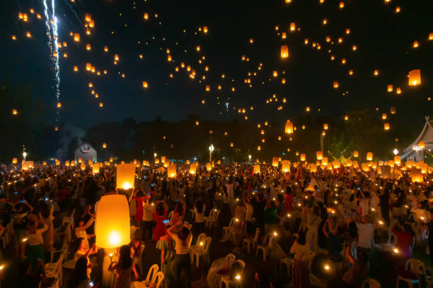 istock Thai people release sky floating lanterns or lamp to worship Buddha's relics at night. Traditional festival in Chiang mai, Thailand. Loy krathong and Yi Peng Lanna ceremony. Celebration background. 1195413961