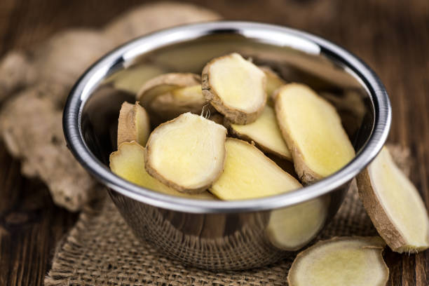 Healthy Raw Ginger on a wooden table as detailed close-up shot (selective focus)