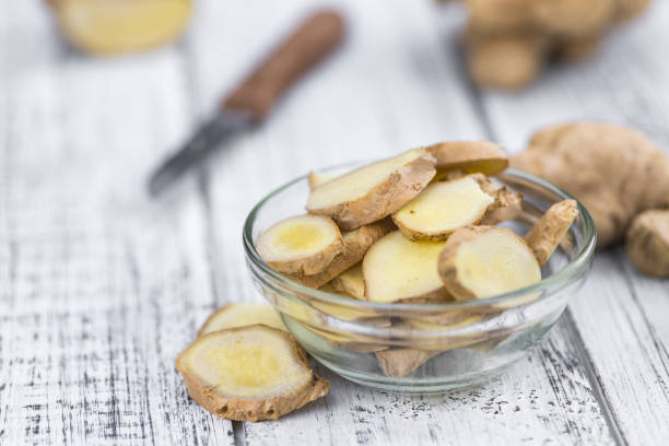 istock Some Ginger Slices on a vintage wooden table (selective focus; close-up shot) 1195415276