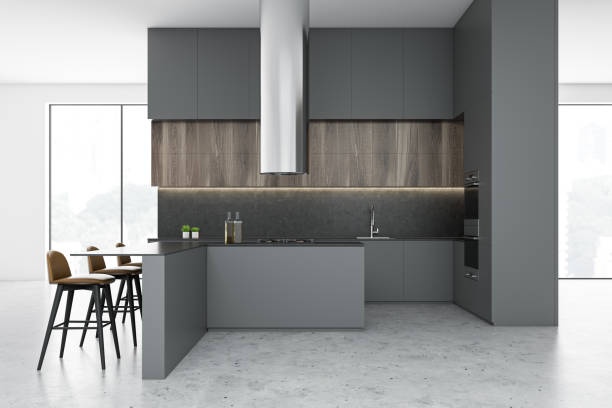 istock Side view of gray and white kitchen with bar 1195415373