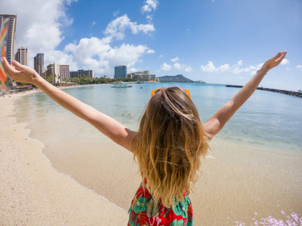 istock Cheerful young woman embracing Hawaii 1195417031