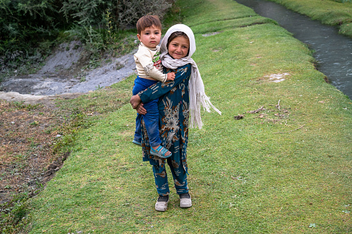 Wakhan Corridor, circa september 2019: Young Afghani girl with a baby boy in Wakhan Corridor, Afghanistan