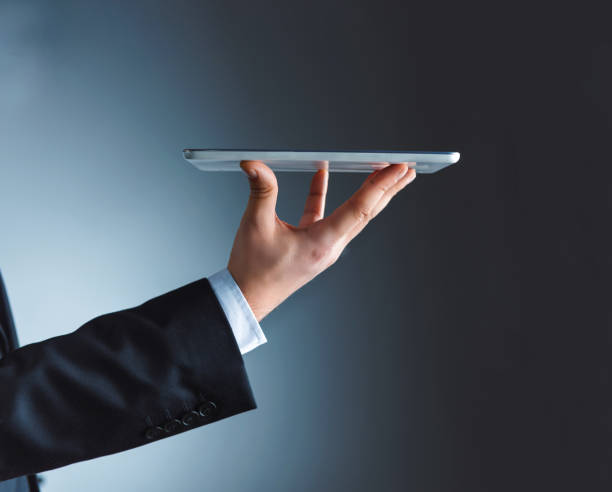 Businessman holds in his hand the digital tablet