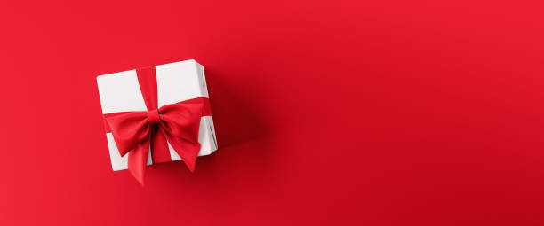 istock White gift box with red ribbon on red background 3d render 1195419717