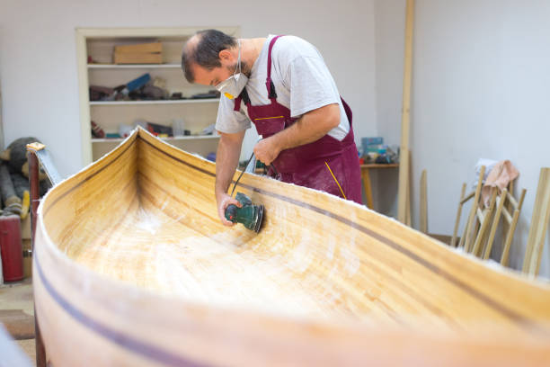 istock Carpenter making wooden boat 1195420761